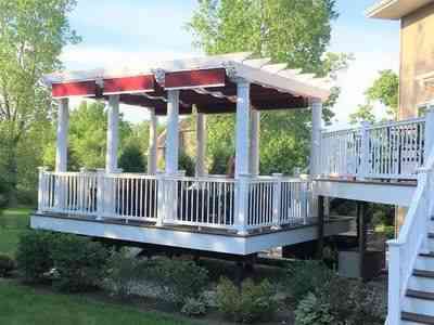 white pergola with red fabric shades