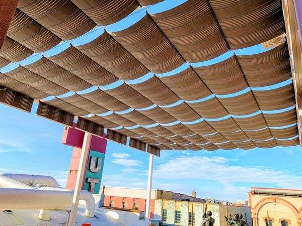 Large retractable shade runners on cables
