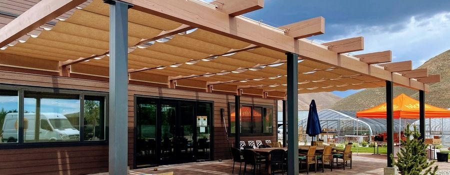 Restaurant patio with tan fabric retractable shades