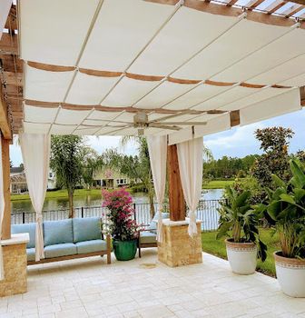 Pergola with added fabric retractable canopies